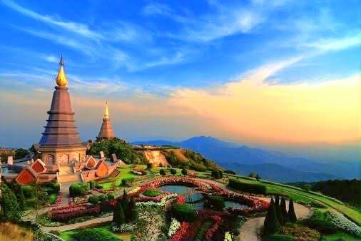 Twin pagodas above gardens at sunset