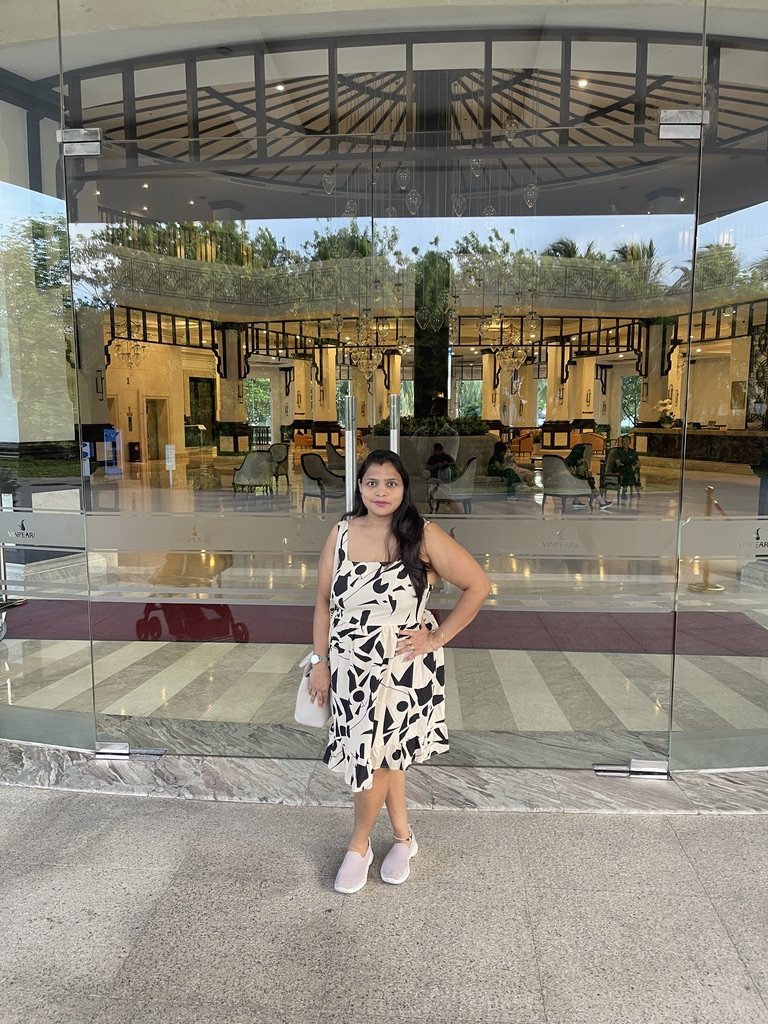 Woman standing in front of a glass hotel entrance